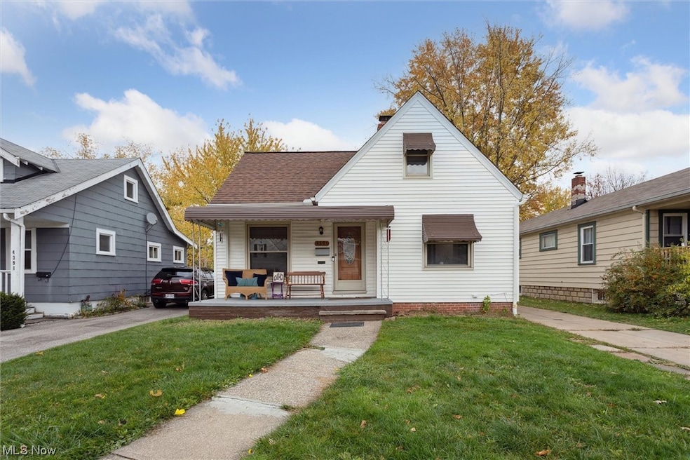 Bungalow with a front yard and covered porch