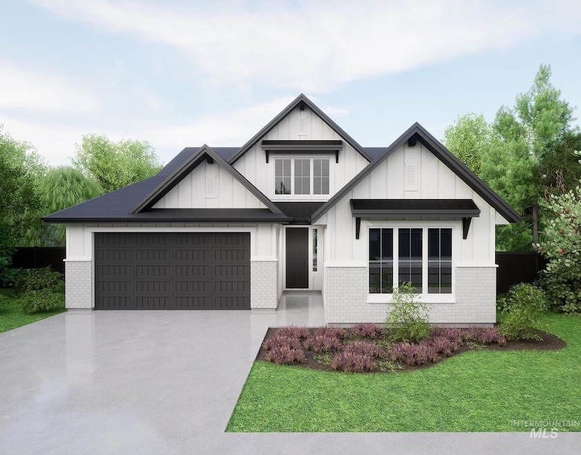 View of front of home featuring concrete driveway, board and batten siding, brick siding, a front yard, and an attached garage