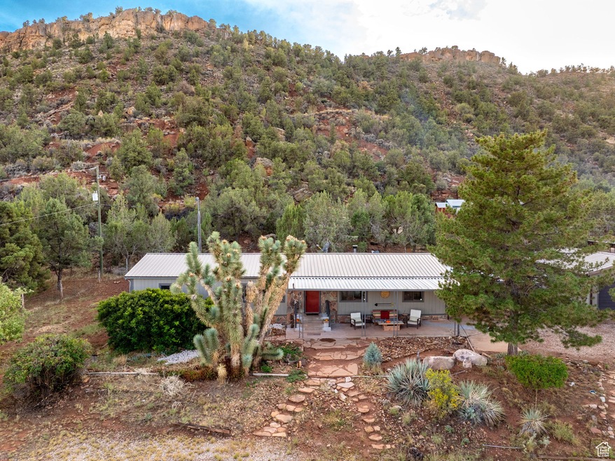 Aerial view of property and surrounding area featuring a mountain backdrop