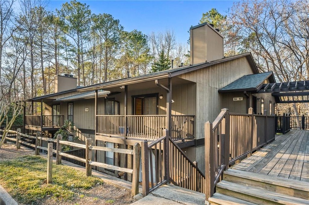 Rear view of house with a wooden deck and a chimne