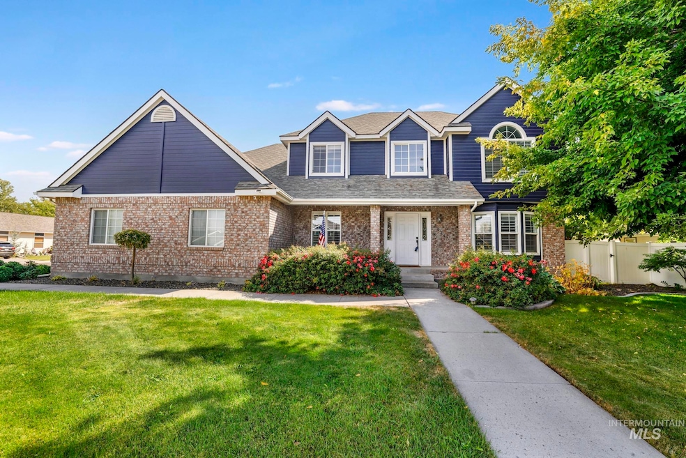 Traditional-style home featuring covered porch, brick siding, and a shingled roof