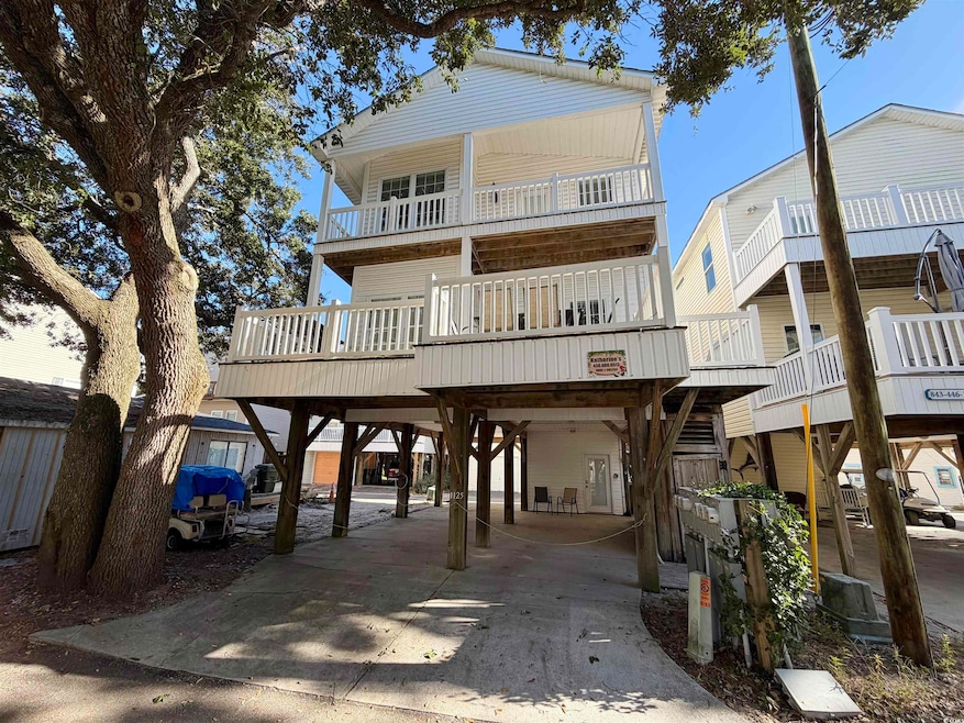 View of front of property featuring a carport and driveway