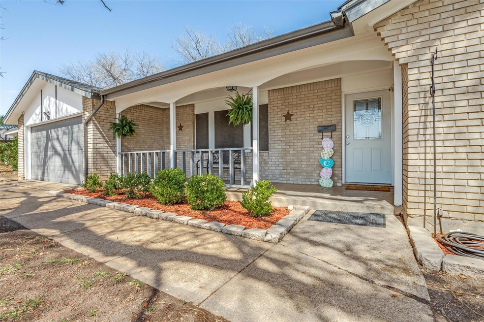 Doorway to property featuring brick siding, covere