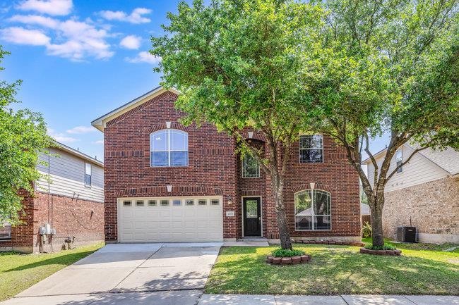 Traditional home featuring a garage, concrete dri
