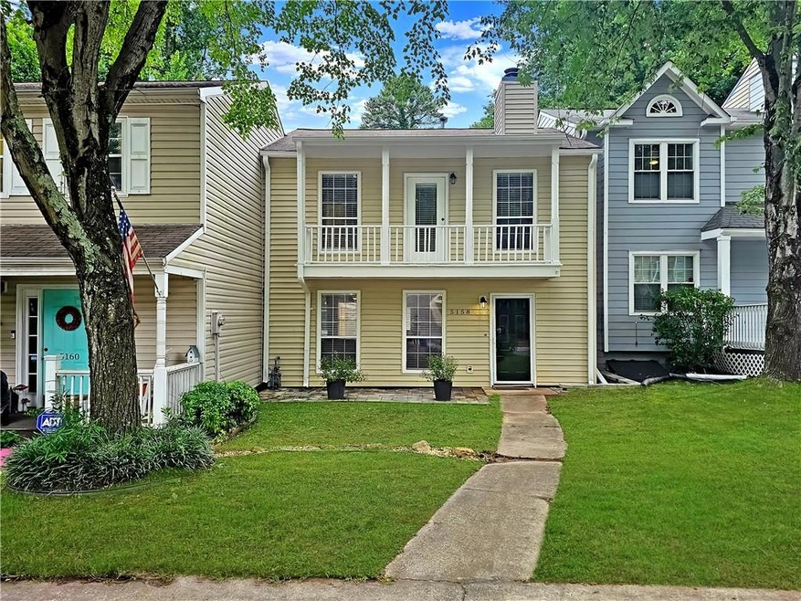 Multi unit property featuring a balcony and a fron