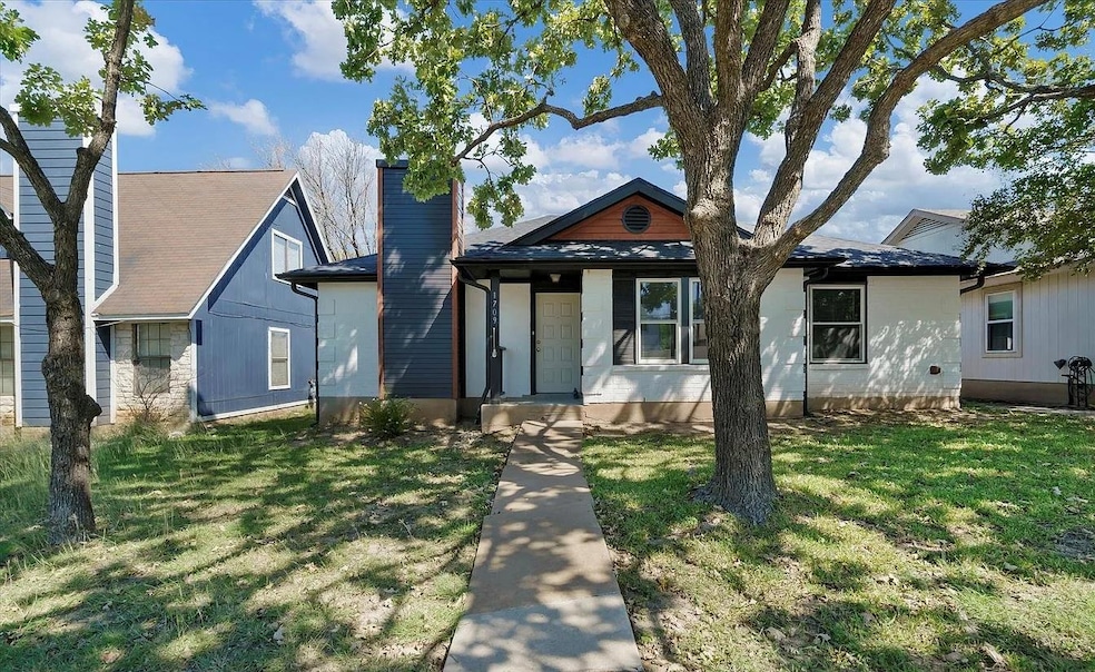 View of front of property featuring a chimney, a 