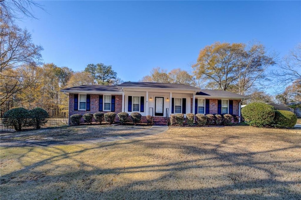 Ranch-style house with a porch and a front lawn