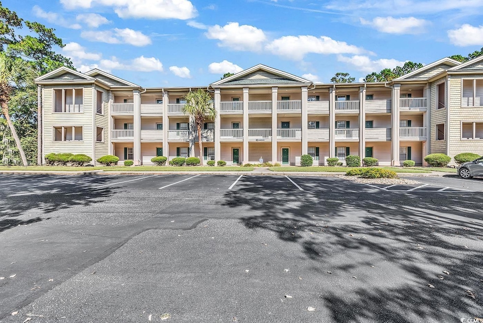 View of property featuring uncovered parking