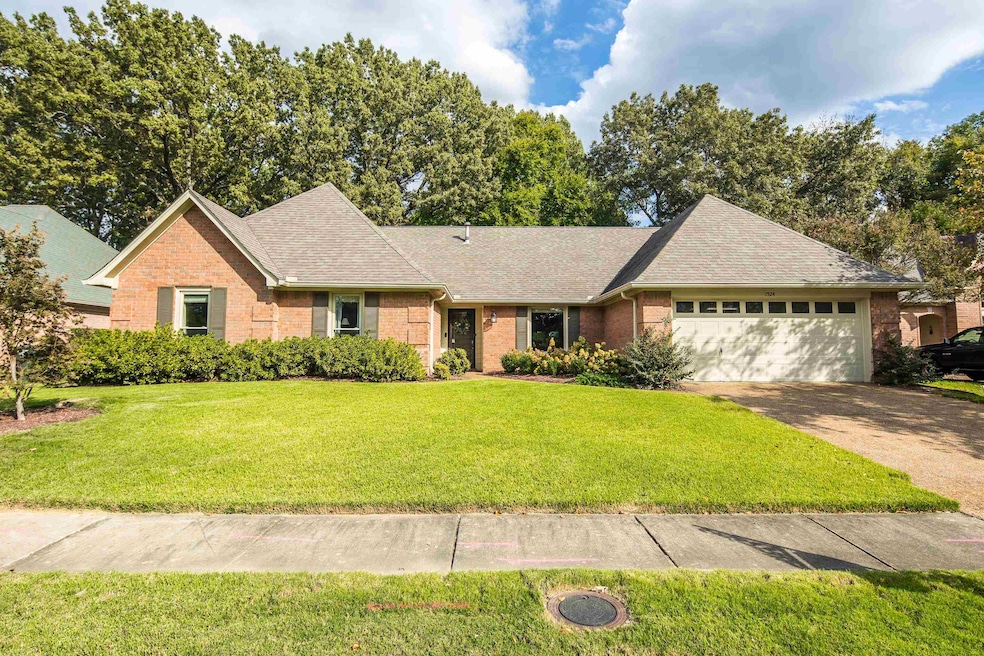 Ranch-style home with a garage and a front lawn