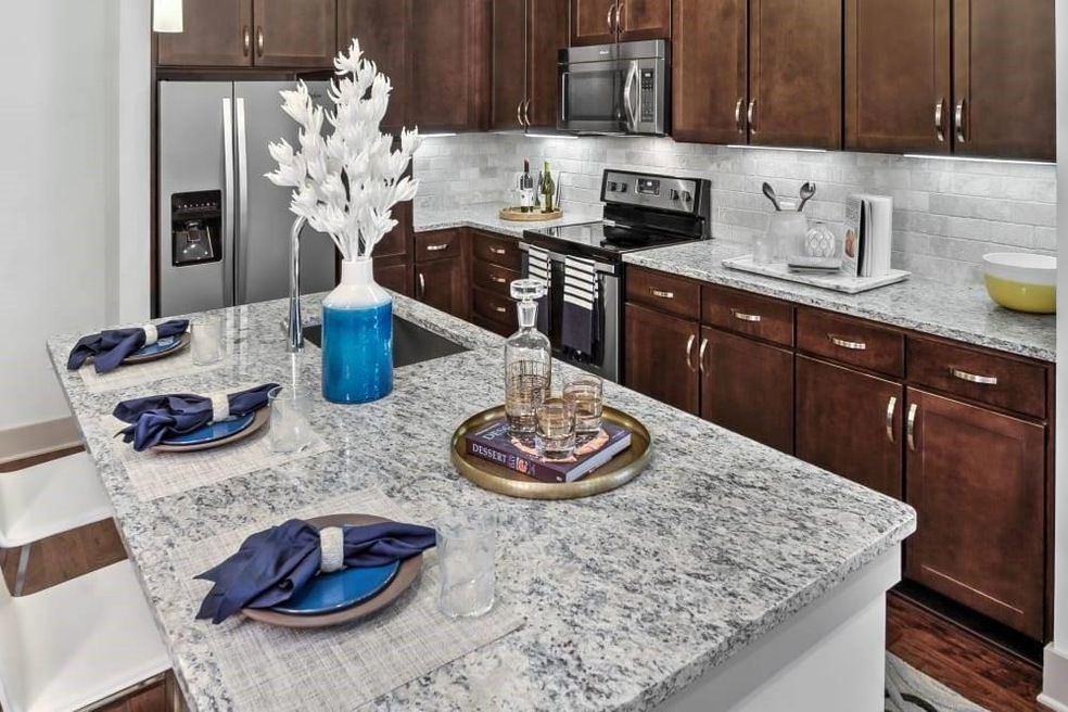 Kitchen featuring light stone countertops, decorat