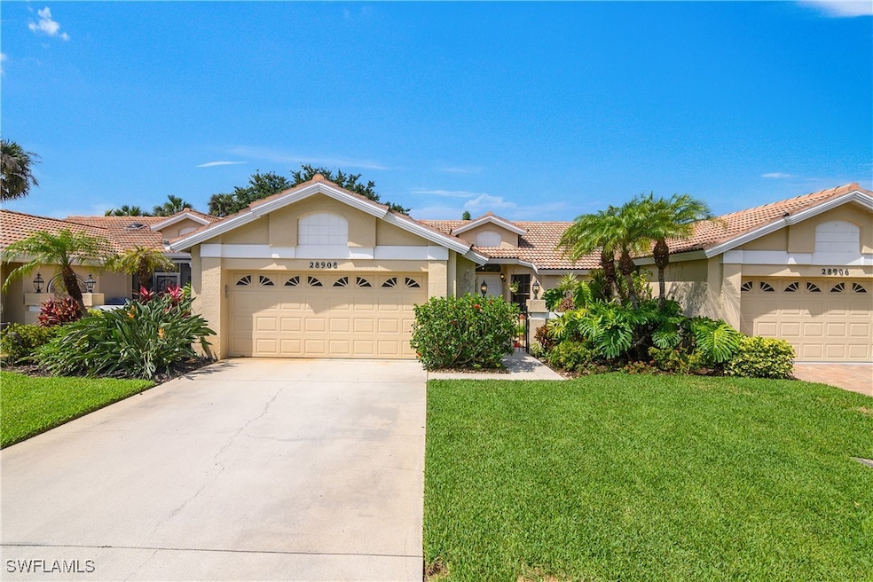 View of front of property featuring a garage, driv