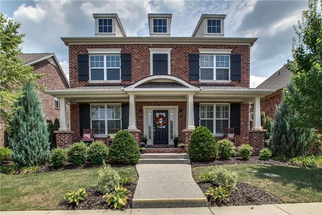 Great curb appeal - front view with covered rocking chair front porch