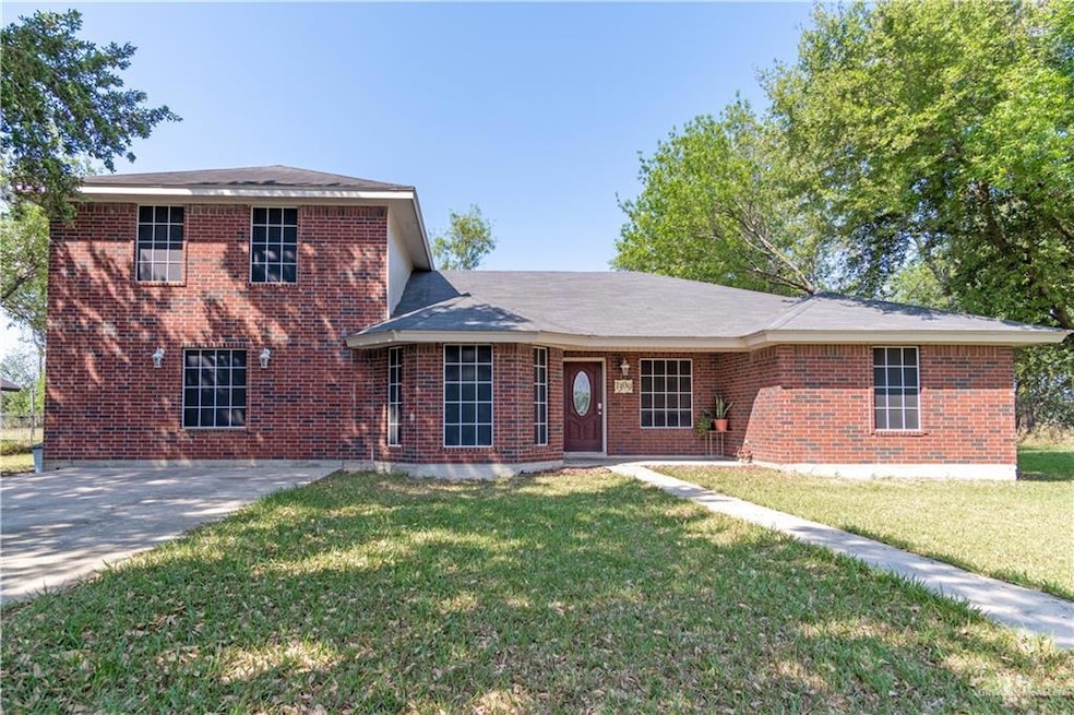 View of front of property with brick siding and a front lawn