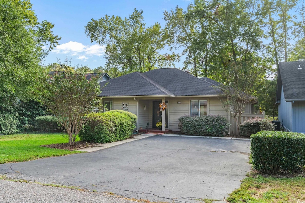 View of front of house with a shingled roof and a front lawn