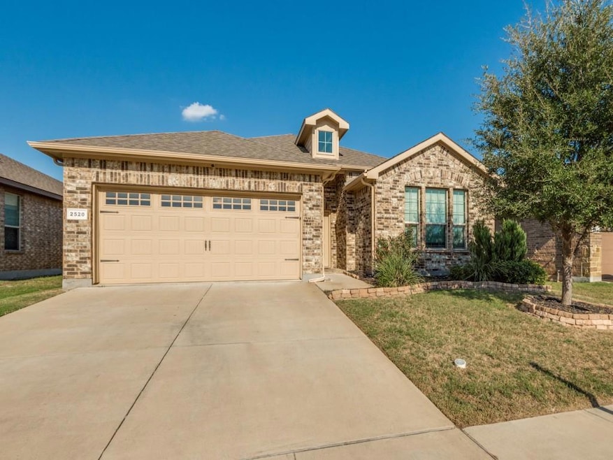 View of front of house featuring a garage and a fr