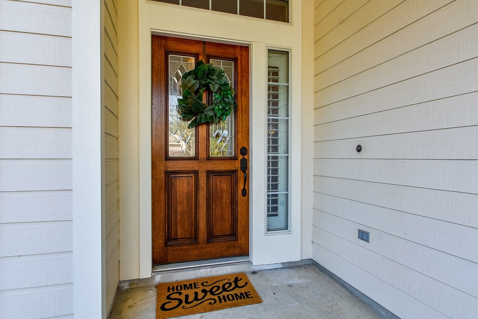 Love the beautiful wood door with glass panels.  They have shutters through out the home.