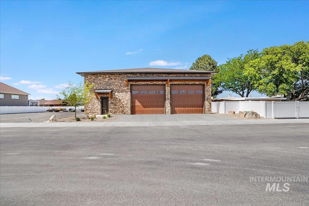 View of front of house featuring stone siding and a garage