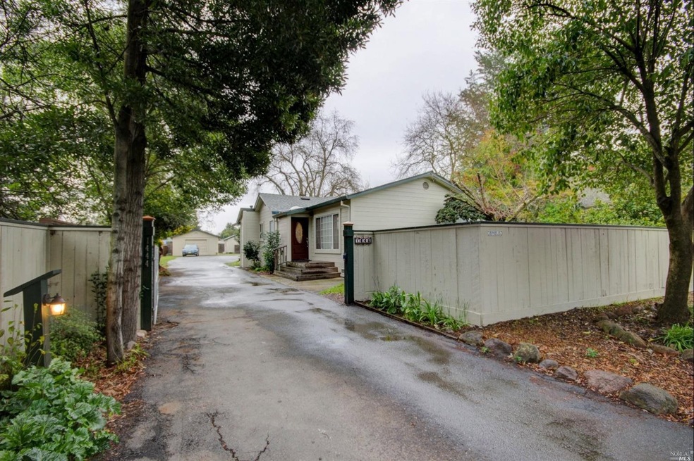 Gated entry and paved driveway welcome you home to