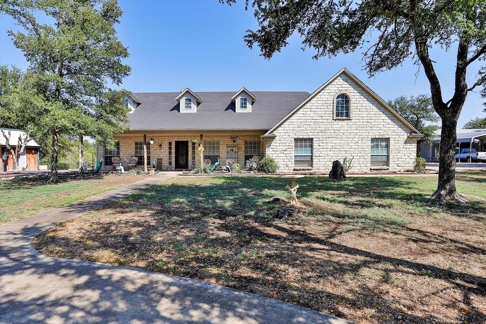 Single story stone home with large covered front p
