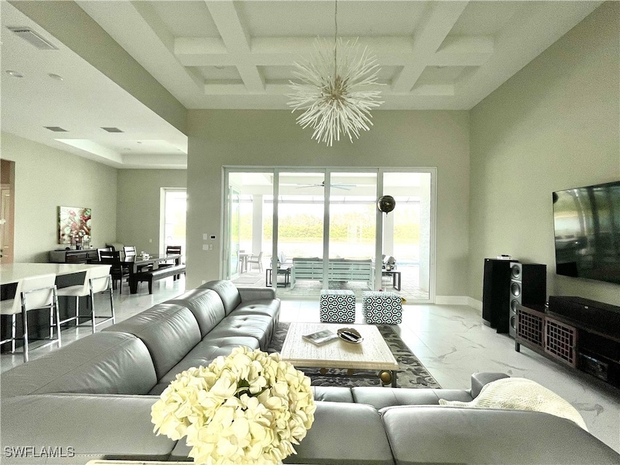 Living room featuring coffered ceiling, beamed cei