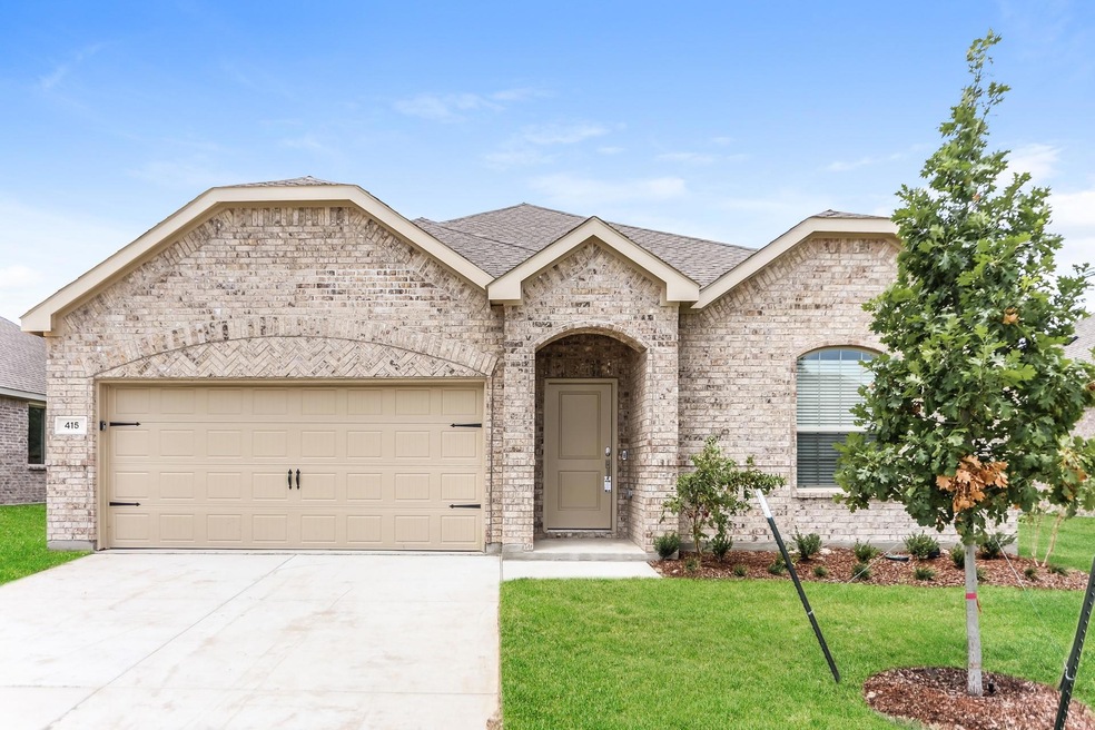 View of front of property with a garage and a front lawn