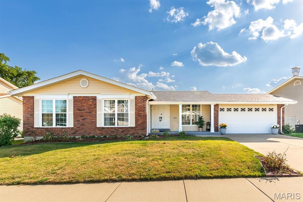 Ranch-style house with covered porch, a front lawn, brick siding, driveway, and a garage