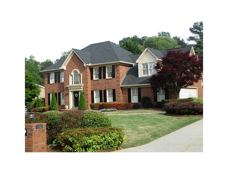 Exterior Front. Front of three-sided brick executi