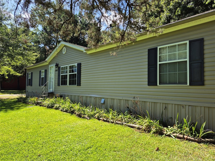 View of side of home with a lawn and entry steps