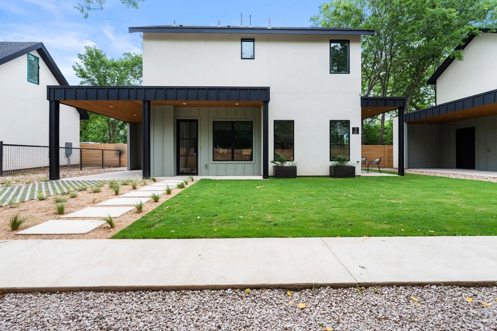 Rear view of property featuring a lawn, board and