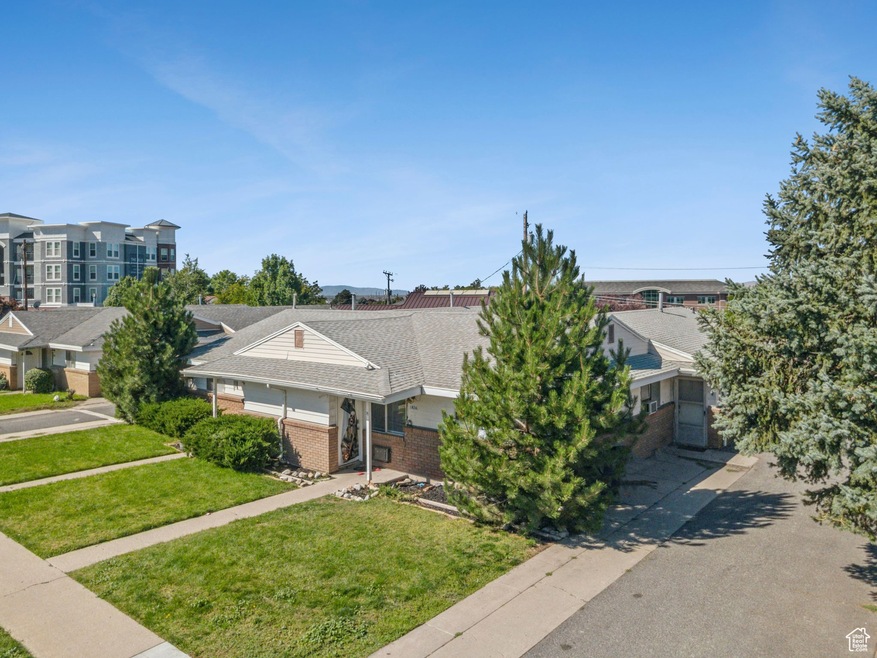 View of front of property with brick siding and a front yard