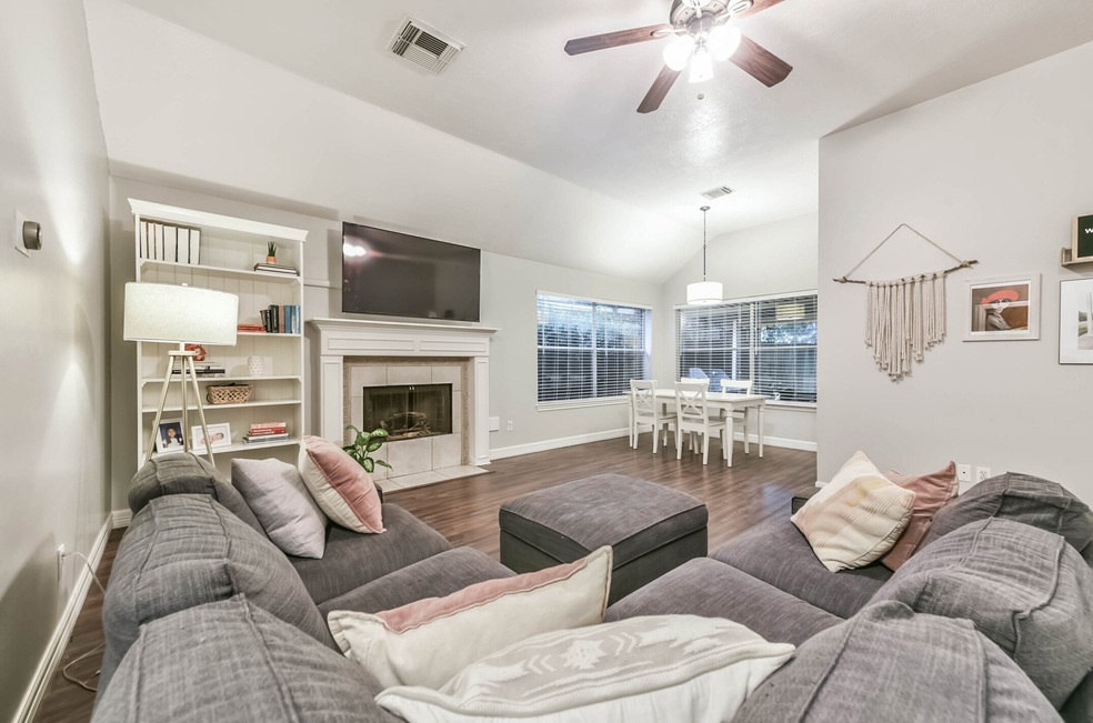 High ceilings, beautiful soft grey color scheme, center hub of your home...this living room is huge and open to many living spaces. Your focal point is your beautiful gas burning fireplace and the great outdoors framed though three large windows in the dining area.