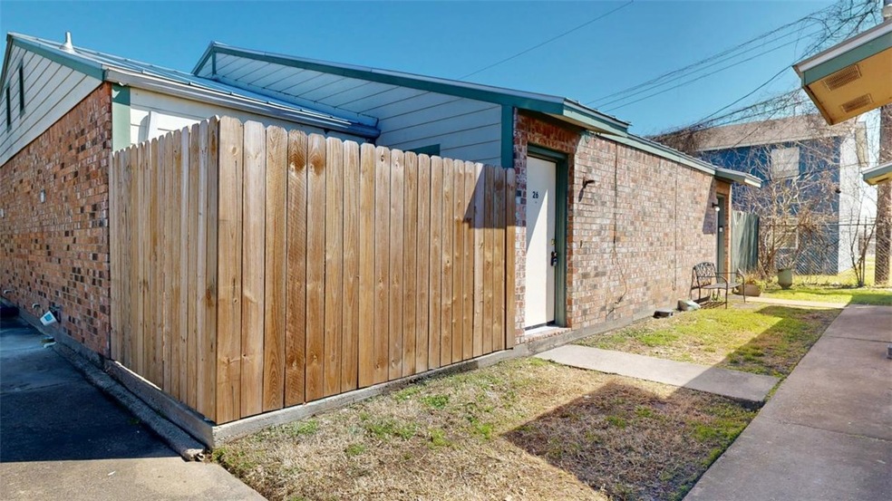 View of home's exterior with fence and brick sidin