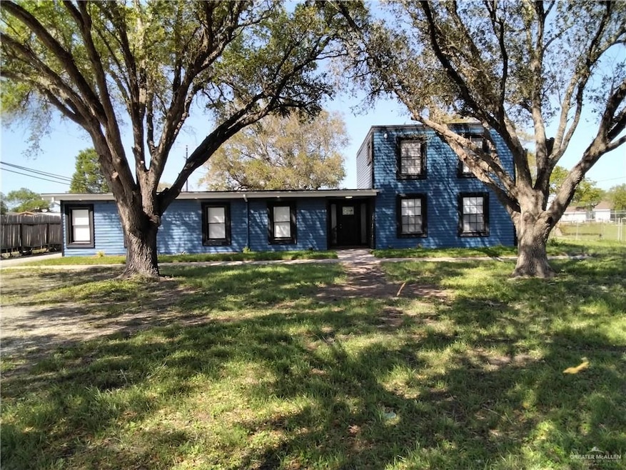 View of front facade featuring a front yard and fence