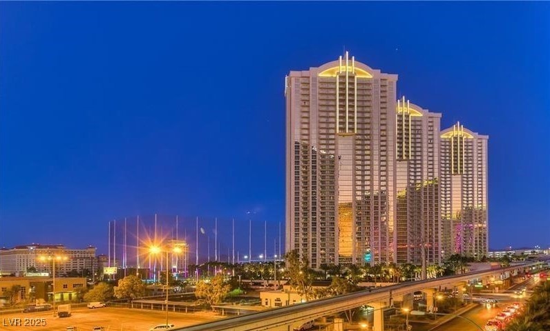 Property at night with a view of city lights