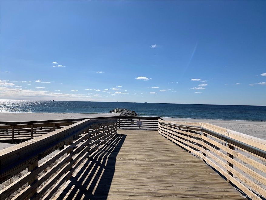 Dock with view of water and beach