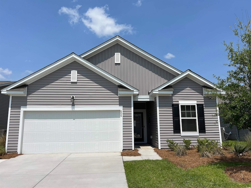 View of front of house featuring driveway and an attached garage
