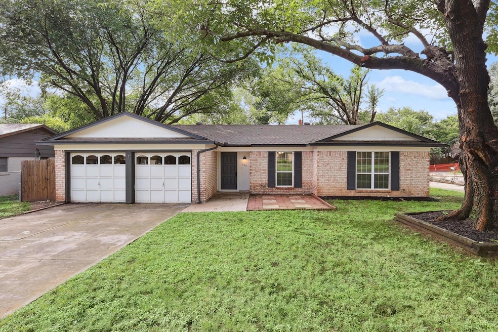 Ranch-style home with a front yard and a garage