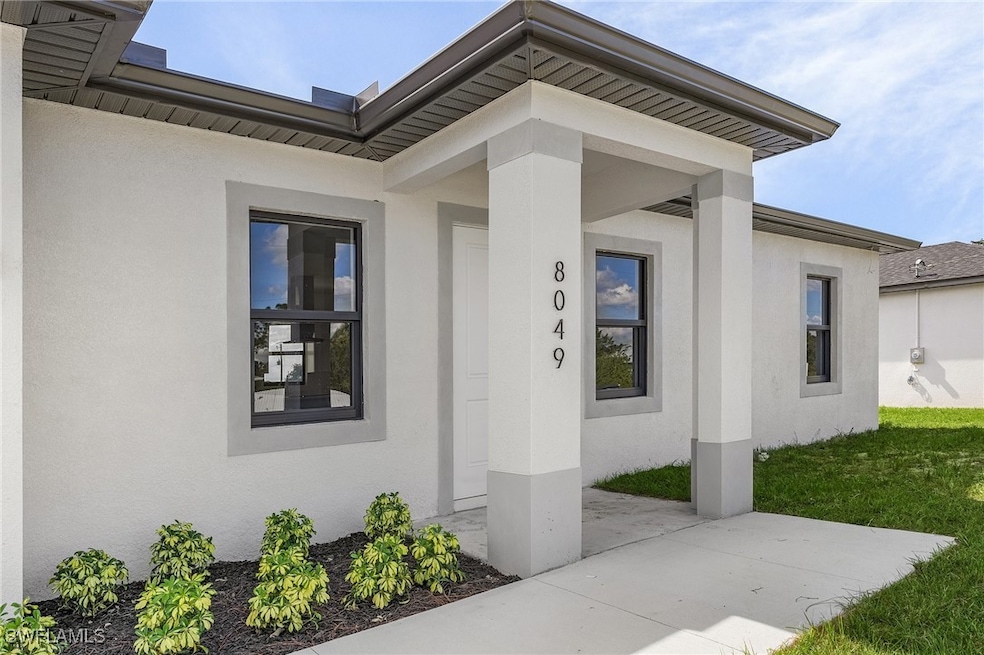 Doorway to property with a lawn