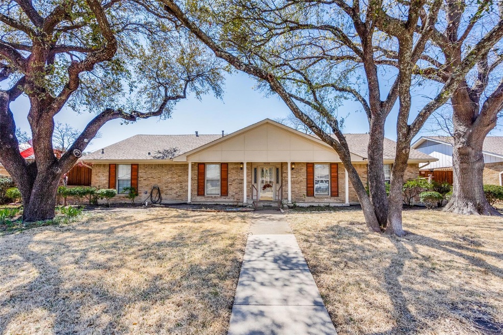 Single story brick, ranch style home with mature t