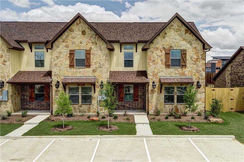 View of front of home featuring stone siding, boar