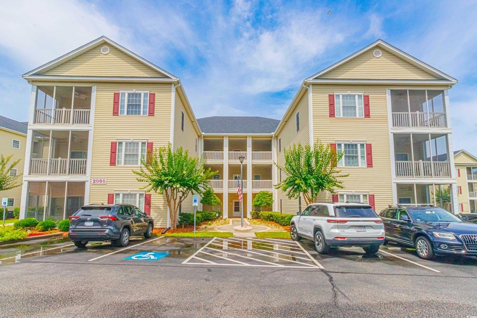 View of building exterior with uncovered parking