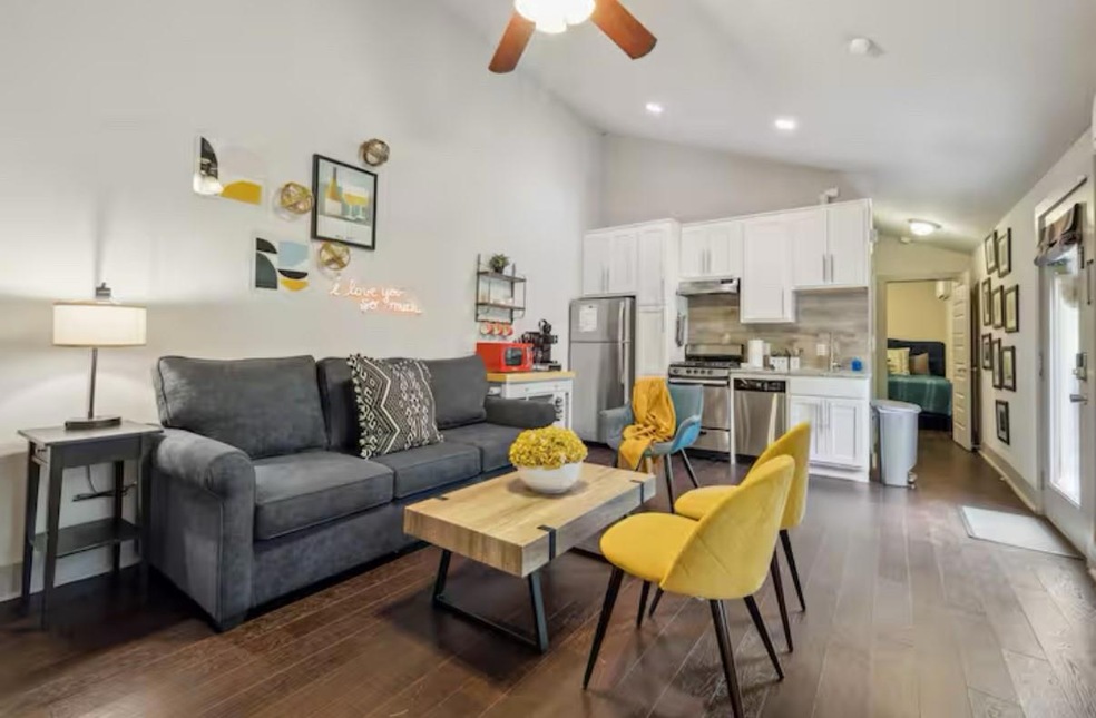 Living room with vaulted ceiling, dark wood-style