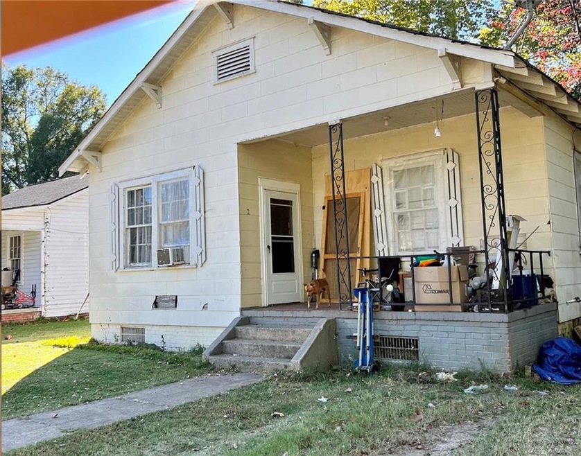 View of front of house with covered porch and a fr