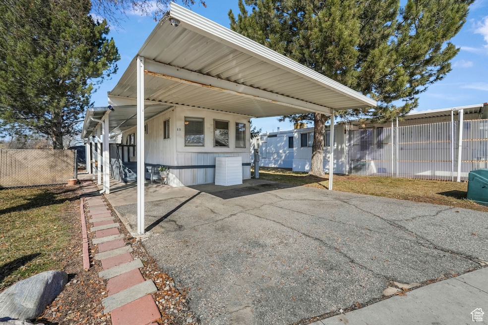 Exterior space with an attached carport and fence