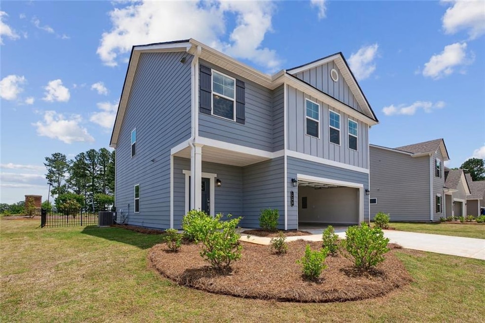 View of front of property featuring a garage, cent