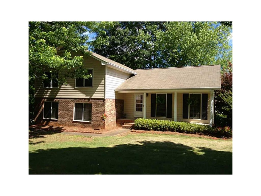 Exterior Front. Inviting home on mature wooded lot