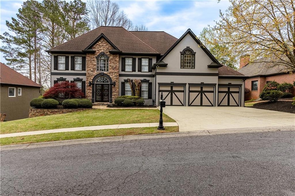 View of front of home with stucco siding, stone si