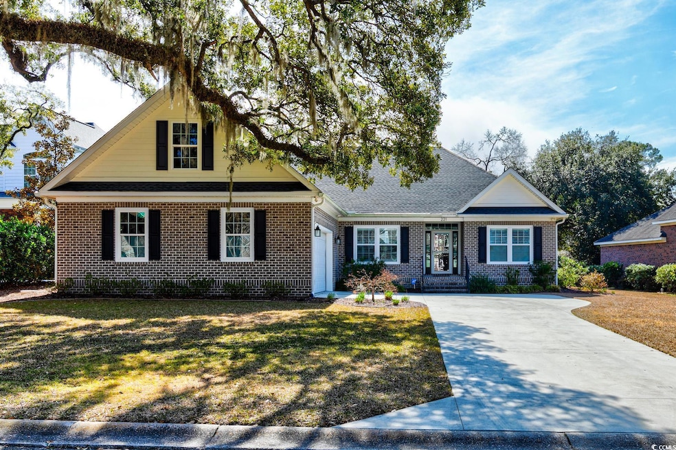 View of front of home with driveway, brick siding,