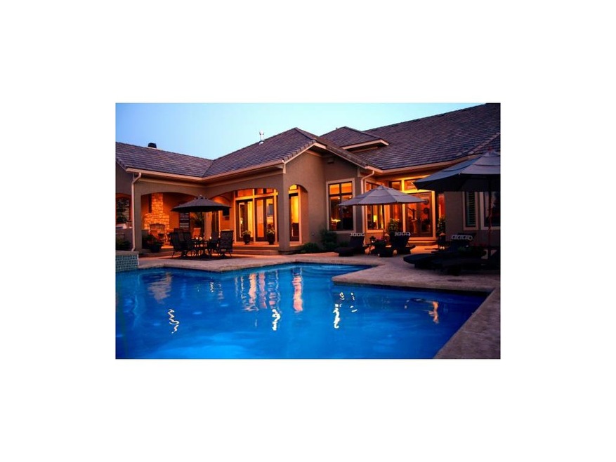 Evening picture of pool and back of home