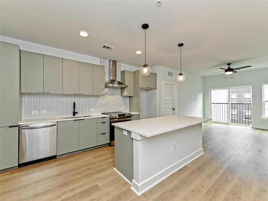 Kitchen with stainless steel appliances, gray cab